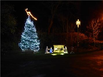 The lit Christmas tree, star and nativity scene - Christmas Lights